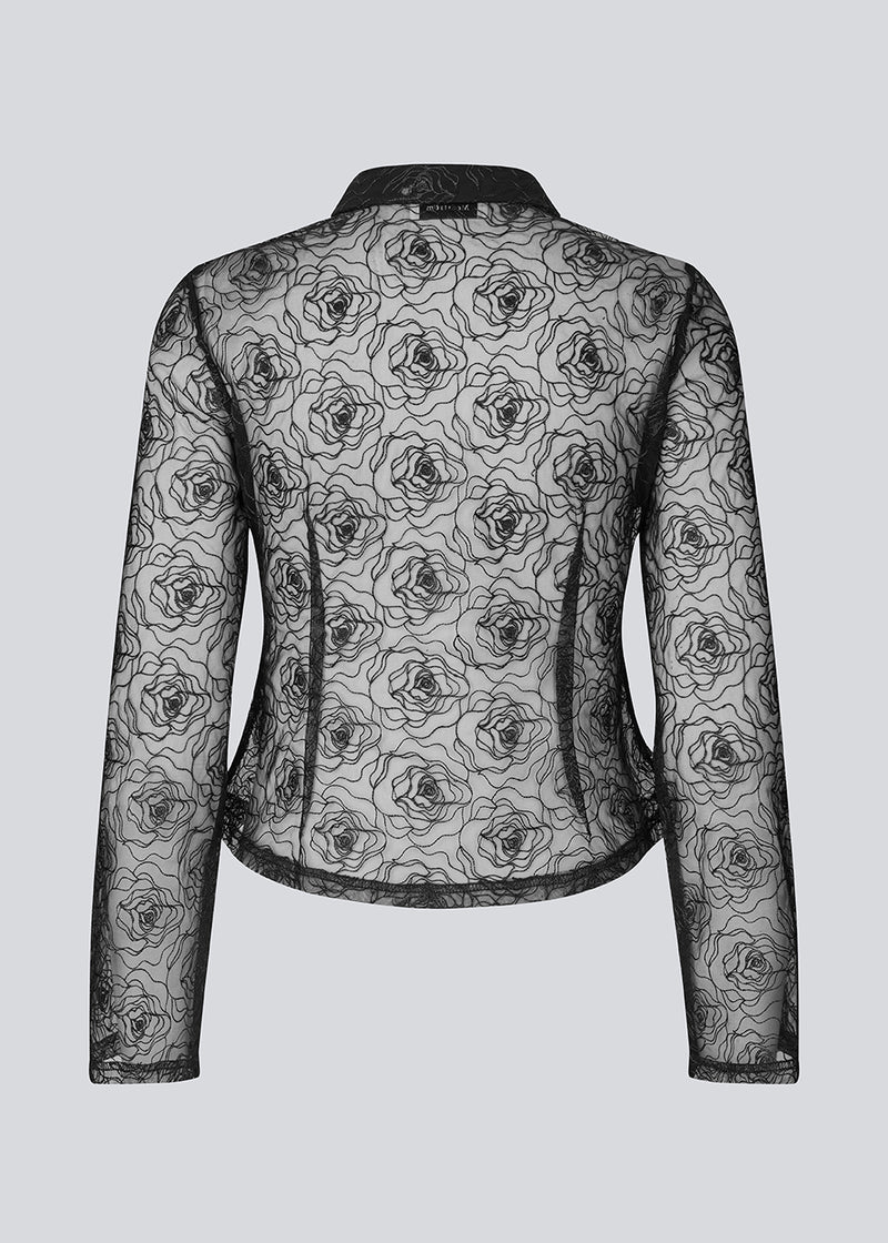 Black fitted shirt in sheer material. The Roccomd shirt features a classic collar and button closure with beautifully stitched rose embroidery – both feminine and stylish.