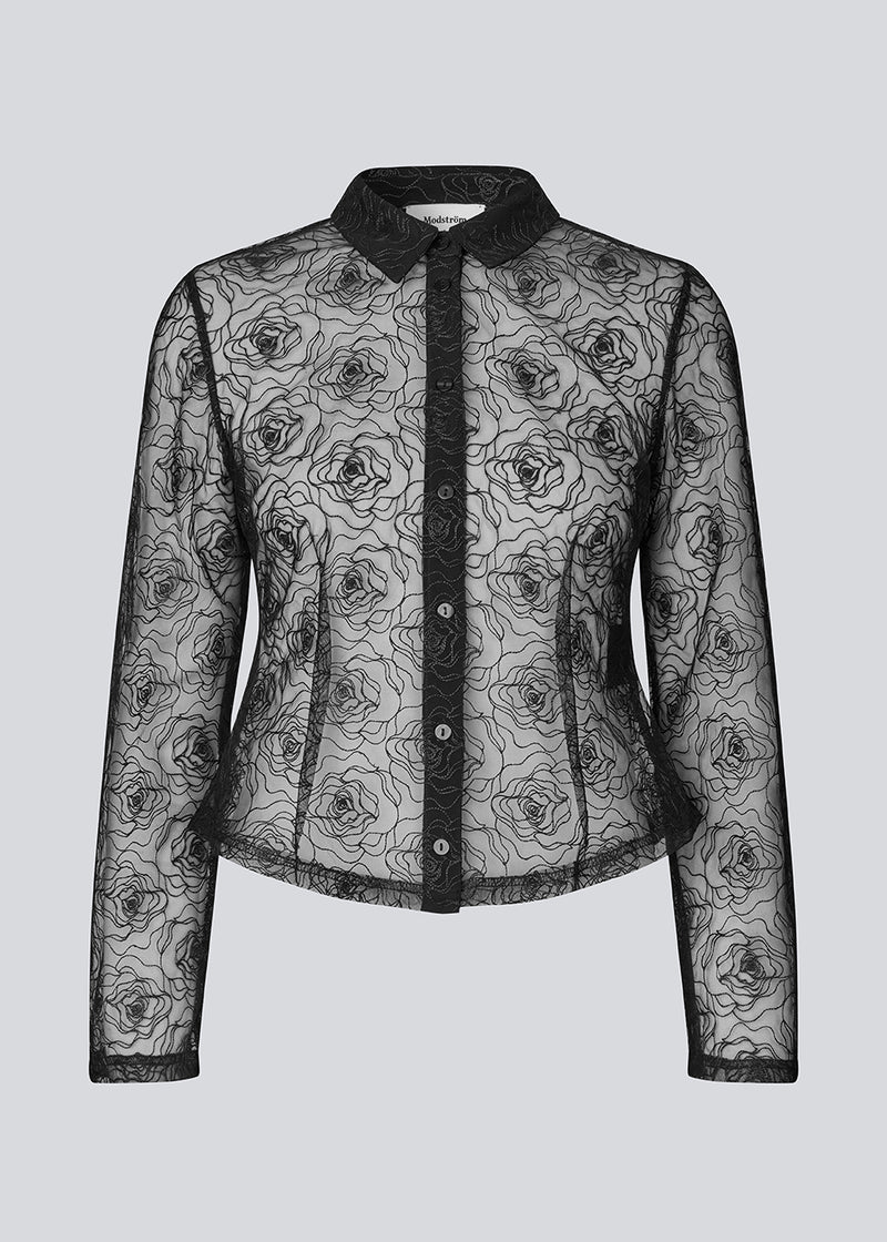 Black fitted shirt in sheer material. The Roccomd shirt features a classic collar and button closure with beautifully stitched rose embroidery – both feminine and stylish.