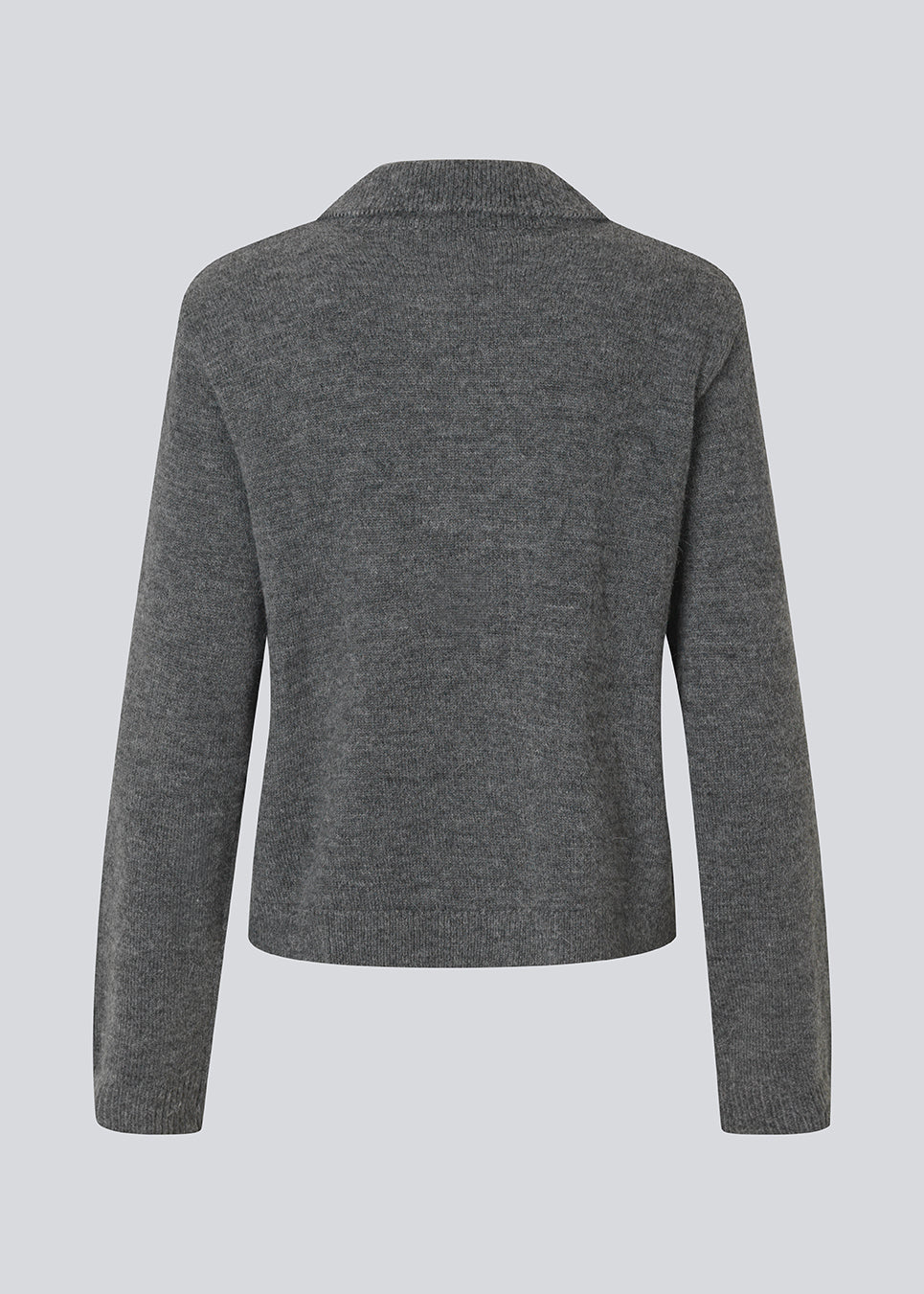 Polo inspired knit with long sleeves. The Roganmd polo knit features a harlequin pattern and an embroidered chest logo – giving it a classic and playful look.