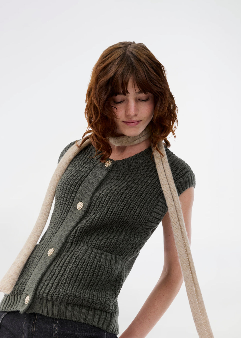 Elegant knitted vest in dark green with a round neckline and decorative buttons at the front. The Scottmd vest is designed in structured knit with ribbed edges, giving a modern and feminine look. Perfect worn on its own or styled over a shirt for a sophisticated layered outfit.

