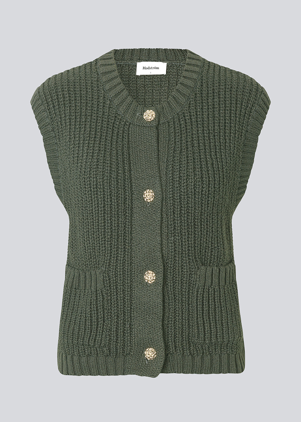 Elegant knitted vest in dark green with a round neckline and decorative buttons at the front. The Scottmd vest is designed in structured knit with ribbed edges, giving a modern and feminine look. Perfect worn on its own or styled over a shirt for a sophisticated layered outfit.
