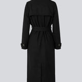 Classic, double-breasted wool coat in black with collar and notch lapels. ShayMD coat has a wide tiebelt at waist, shoulder straps, wide cuffs and open yoke. With lining and single back vent.