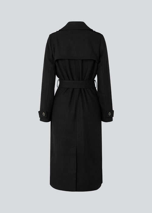 Classic, double-breasted wool coat in black with collar and notch lapels. ShayMD coat has a wide tiebelt at waist, shoulder straps, wide cuffs and open yoke. With lining and single back vent.