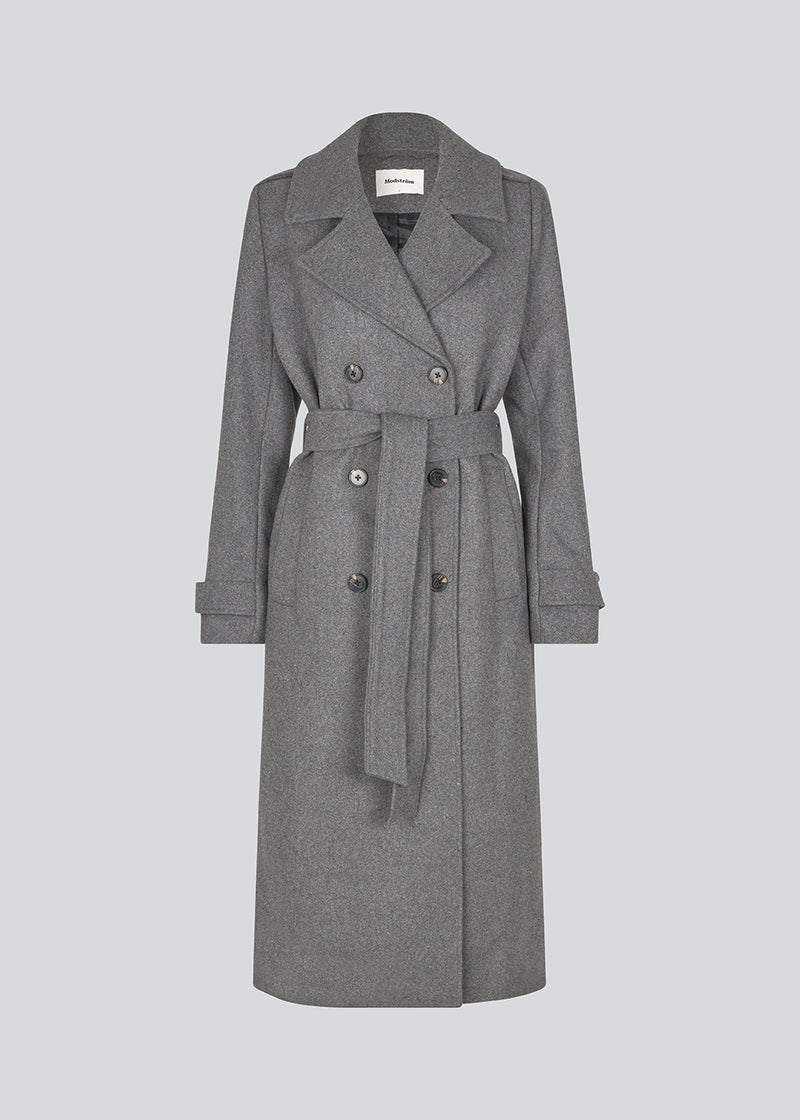 Classic, double-breasted wool coat in grey with collar and notch lapels. ShayMD coat has a wide tiebelt at waist, shoulder straps, wide cuffs and open yoke. With lining and single back vent.