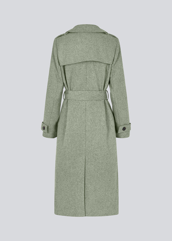 Classic, double-breasted wool coat in a green color with collar and notch lapels. ShayMD coat has a wide tiebelt at waist, shoulder straps, wide cuffs and open yoke. With lining and single back vent.