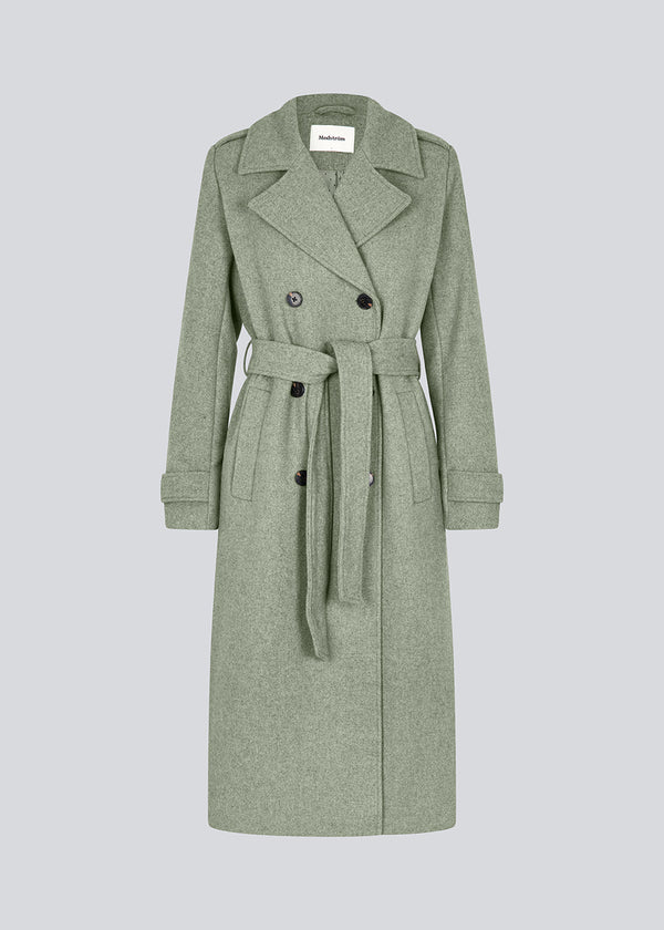 Classic, double-breasted wool coat in a green color with collar and notch lapels. ShayMD coat has a wide tiebelt at waist, shoulder straps, wide cuffs and open yoke. With lining and single back vent.