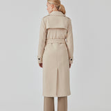 Classic, double-breasted wool coat in beige with collar and notch lapels. ShayMD coat has a wide tiebelt at waist, shoulder straps, wide cuffs and open yoke. With lining and single back vent.