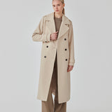 Classic, double-breasted wool coat in beige with collar and notch lapels. ShayMD coat has a wide tiebelt at waist, shoulder straps, wide cuffs and open yoke. With lining and single back vent.
