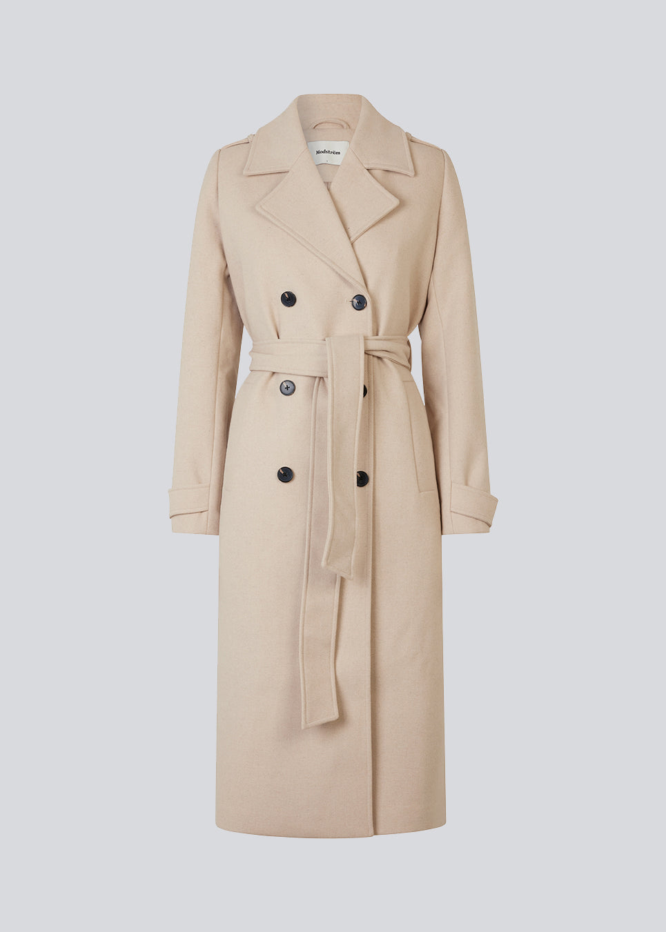 Classic, double-breasted wool coat in beige with collar and notch lapels. ShayMD coat has a wide tiebelt at waist, shoulder straps, wide cuffs and open yoke. With lining and single back vent.