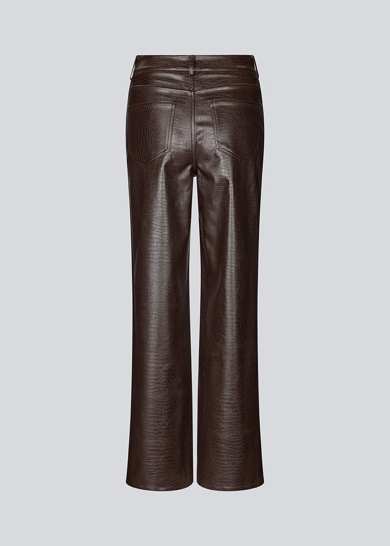 Faux leather trousers in dark brown with crocodile print. Sixstenmd pants have straight legs, pockets, belt loops and hidden zipper. A cool pair of trousers that will give your outfit plenty of edge.