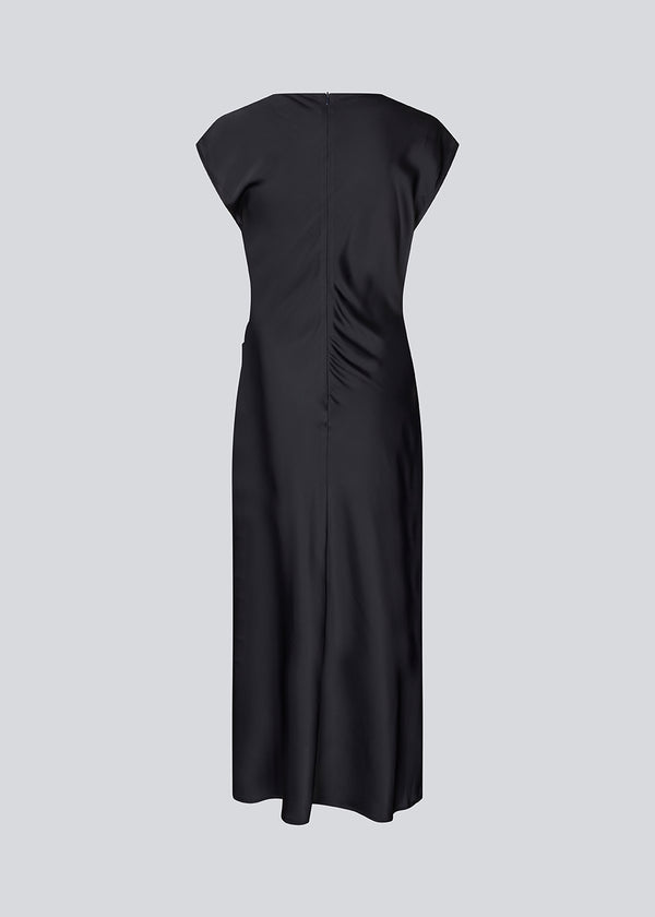 Dark blue Sleeveless maxi dress with pleats in the side. TailorMD dress is made in satin and has a high neck, invisible zipper in the back and a slit in the side seam.