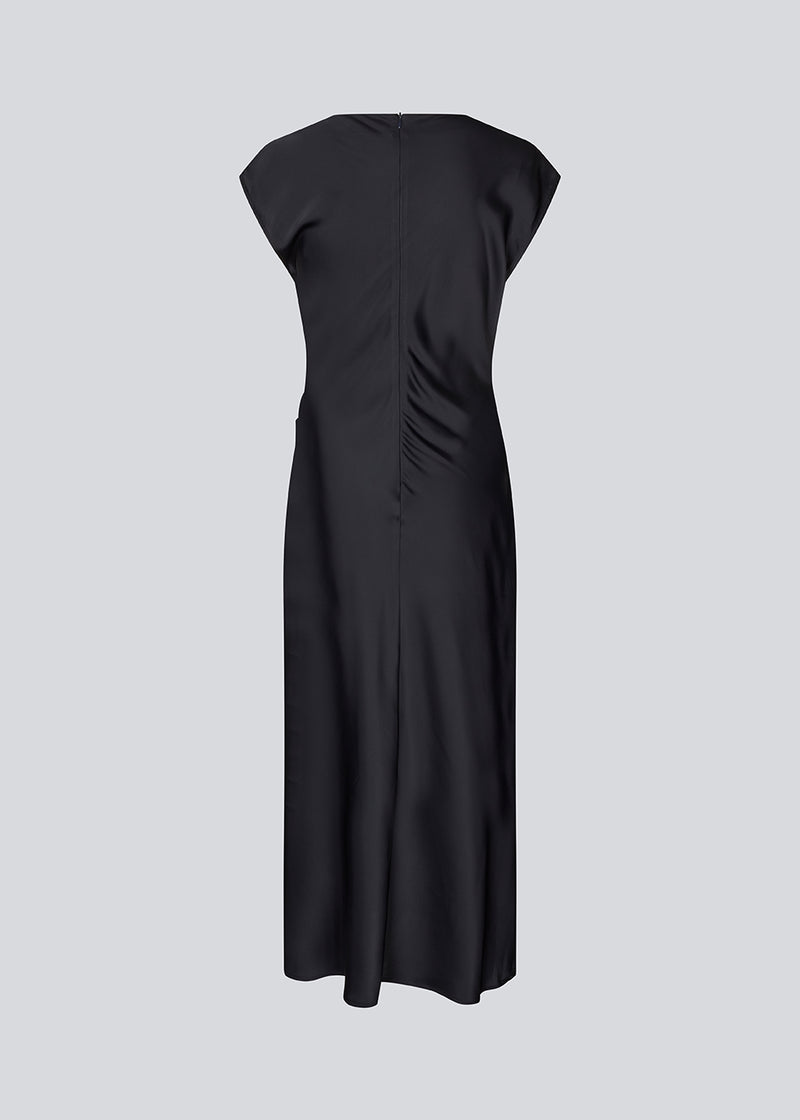 Dark blue Sleeveless maxi dress with pleats in the side. TailorMD dress is made in satin and has a high neck, invisible zipper in the back and a slit in the side seam.