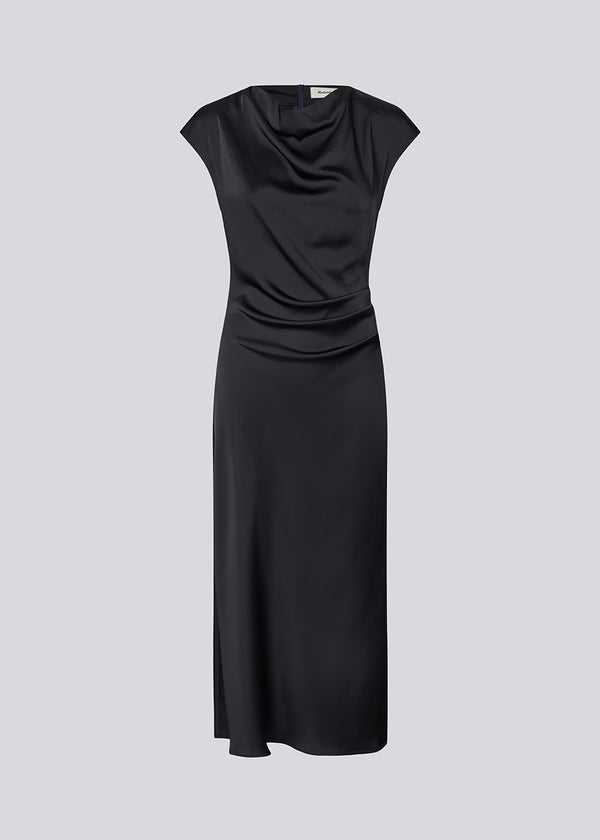 Dark blue Sleeveless maxi dress with pleats in the side. TailorMD dress is made in satin and has a high neck, invisible zipper in the back and a slit in the side seam.