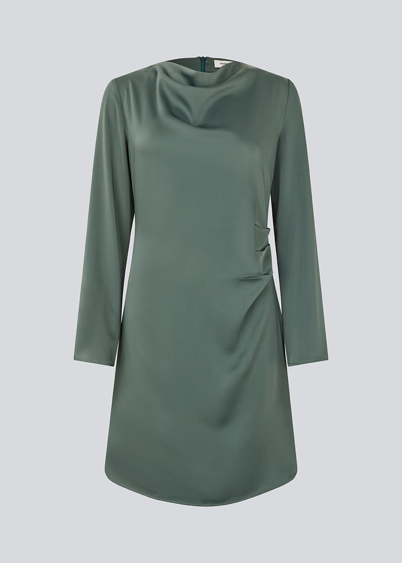Short dress in green with flattering gathering at the waist and slight waterfall neckline. TailorMD dress is made in a beautiful satin and has long sleeves and an invisible zipper in the back.
