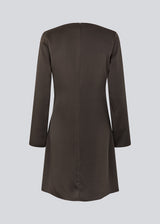 Our very popular and always sold out Tailormd dress now in a new shorter version with long sleeves.&nbsp;The dress is brown and has flattering gathering at the waist and a slight waterfall neckline. The TailorMD dress is made in a beautiful satin and has long sleeves and an invisible zipper in the back.