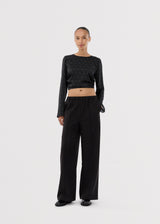 Long-sleeved satin top in black with white small dots. The TailorMD print top features a flattering open back with tie closure – combining elegance with a statement print.