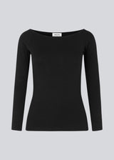 Tansy LS top in black has a simple expression with a wide neckline and long, slim sleeves. The top has a tight-fitted silhouette.