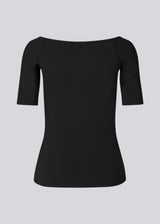 Tansy top in black has a simple look with a wide neckline at front and back and narrow sleeves. The top is slim fit without being tight. A basic must-have style in your waredrobe.