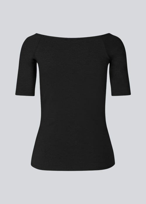 Tansy top in black has a simple look with a wide neckline at front and back and narrow sleeves. The top is slim fit without being tight. A basic must-have style in your waredrobe.