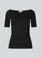 Tansy top in black has a simple look with a wide neckline at front and back and narrow sleeves. The top is slim fit without being tight. A basic must-have style in your waredrobe.