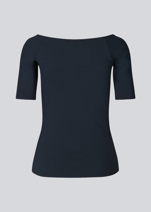 Tansy top in navy noir has a simple look with a wide neckline at front and back and narrow sleeves. The top is slim fit without being tight.