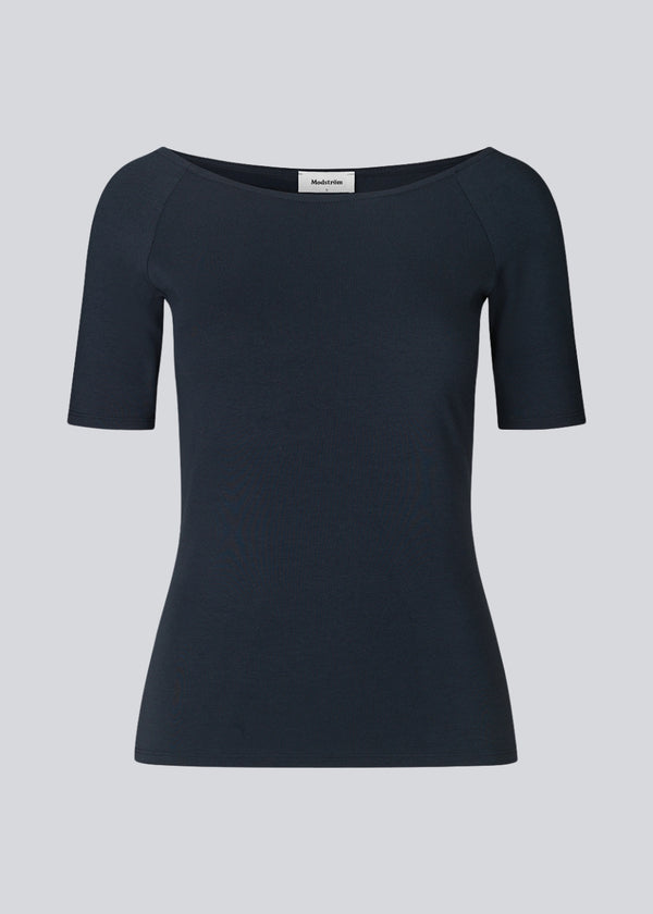 Tansy top in navy noir has a simple look with a wide neckline at front and back and narrow sleeves. The top is slim fit without being tight.