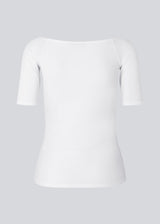 Tansy top in white has a simple look with a wide neckline at front and back and narrow sleeves. The top is slim fit without being tight.