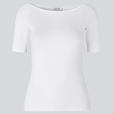 Tansy top in white has a simple look with a wide neckline at front and back and narrow sleeves. The top is slim fit without being tight.