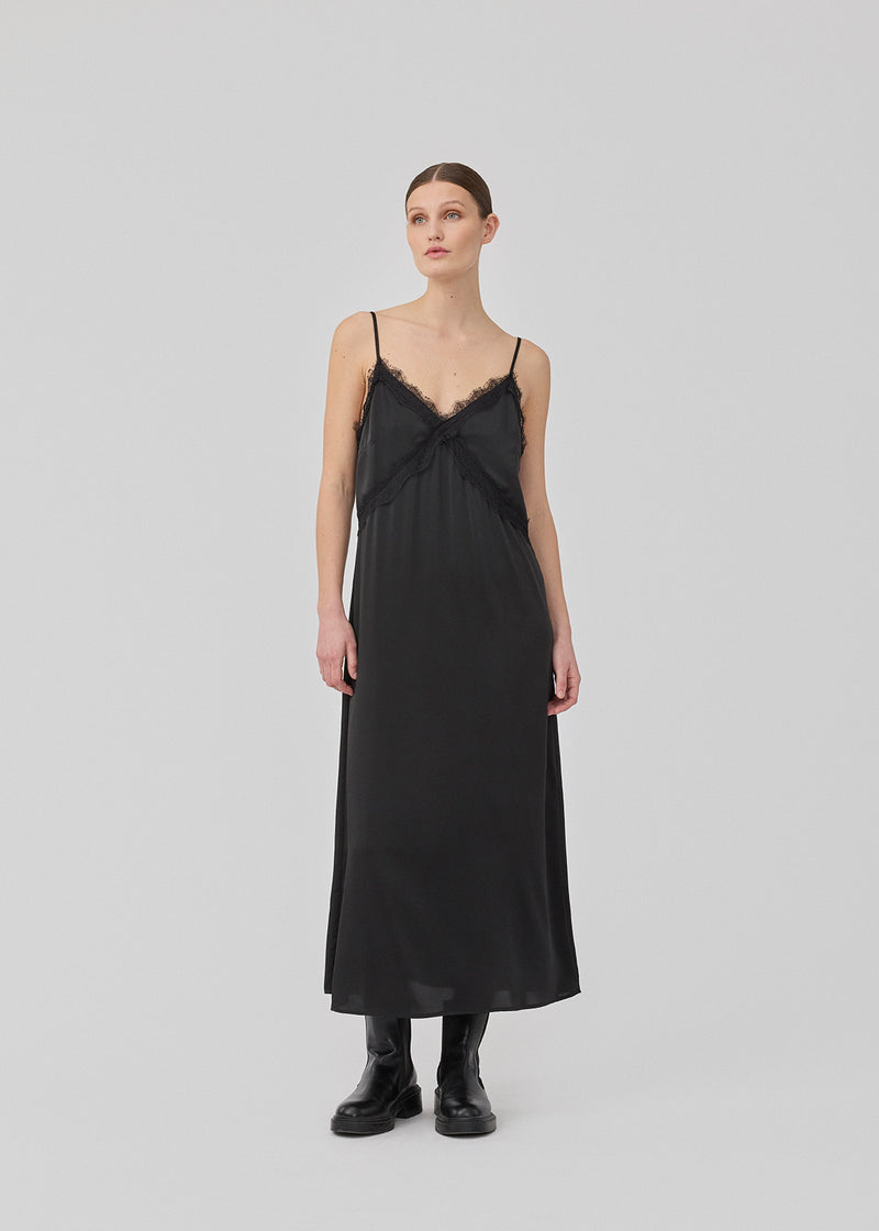 Maxi satin dress with a soft drape. TenjaMD dress is detailed with lacing on the front and has thin straps.