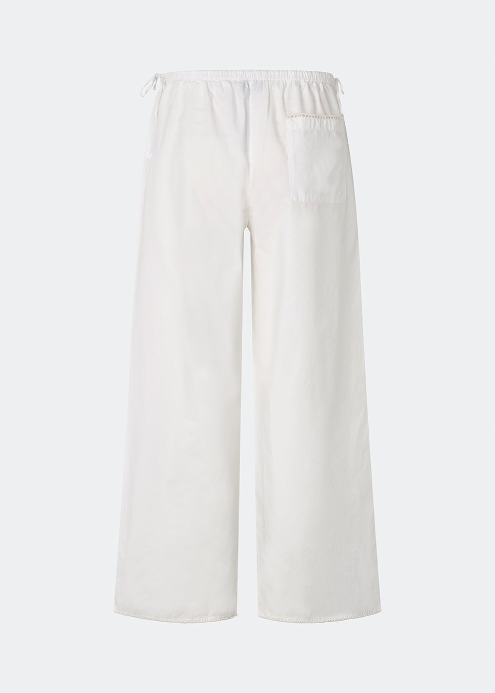 Lightweight trousers crafted from a soft cotton quality. Tessamd pants feature wide legs, an elasticated waistband with adjustable side ties, and a clean, relaxed look. A comfortable and versatile style that combines minimalist design with a modern fit.