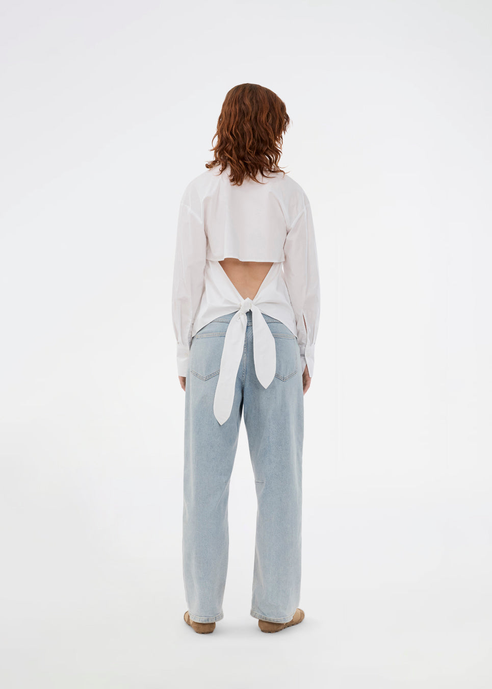 Fitted white shirt with an open back with a tiedetail. Thememd shirt has a shirt collar and a button closure in front. The model is 175 cm and wears a size s/36.

Material:
97% Cotton
3% Elastane