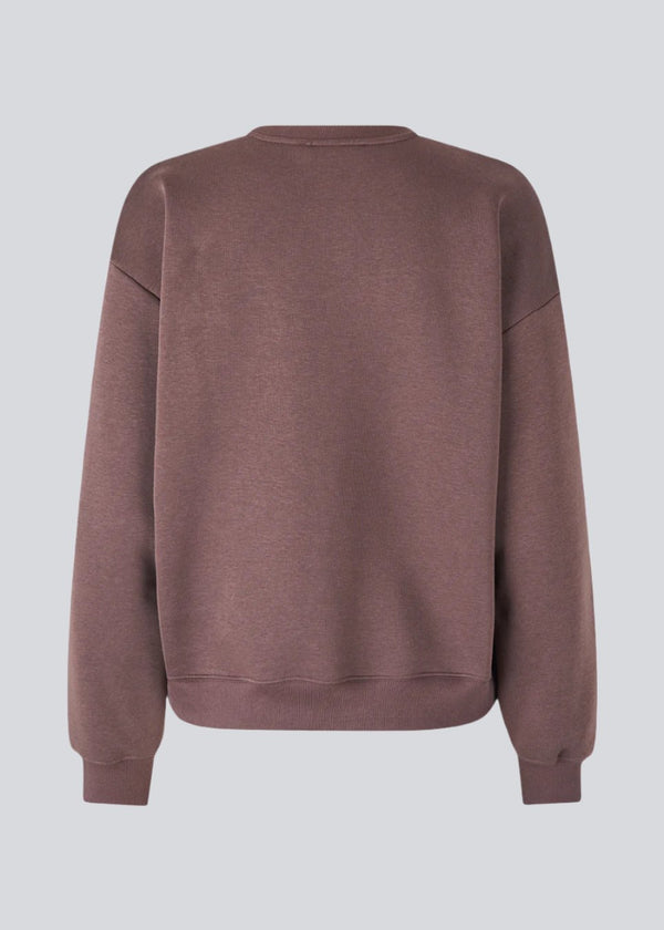 Sweatshirt with logo made in a cotton mixture in brown. TiaMD sweat has a round neckline and ribbing at the sleeves and bottom. The model is 175 cm and wears a size S/36.