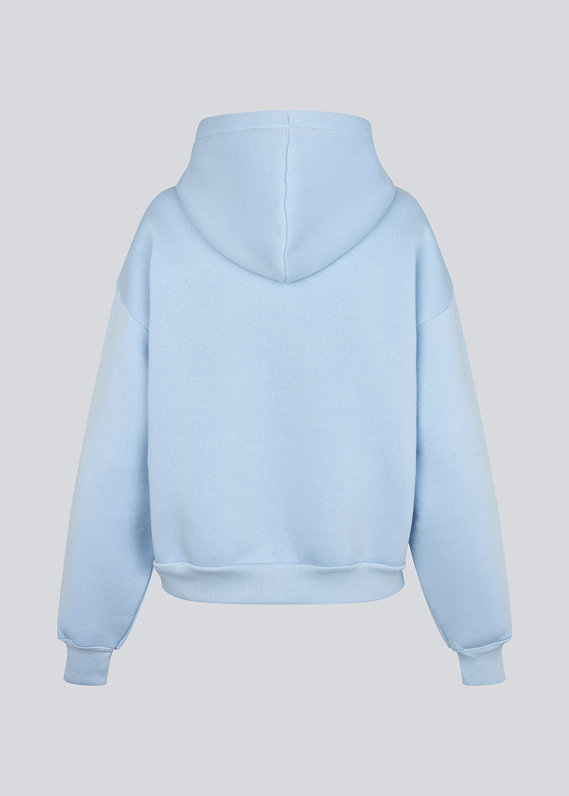 Hoodie in light blue/baby blue with a zipper and logo in a cotton mixture. TiaMD Zip has pockets, ribbing at the sleeves and bottom and a hood with strings.