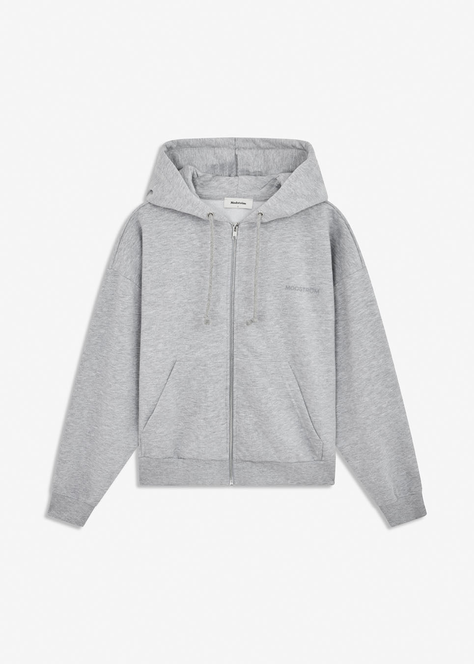 Sweatshirt in grey with a zipper and logo in a cotton mixture. TiaMD Zip is a hoodie with pockets, ribbing at the sleeves and bottom and a hood with strings. The model is 175 cm and wears a size S/36.