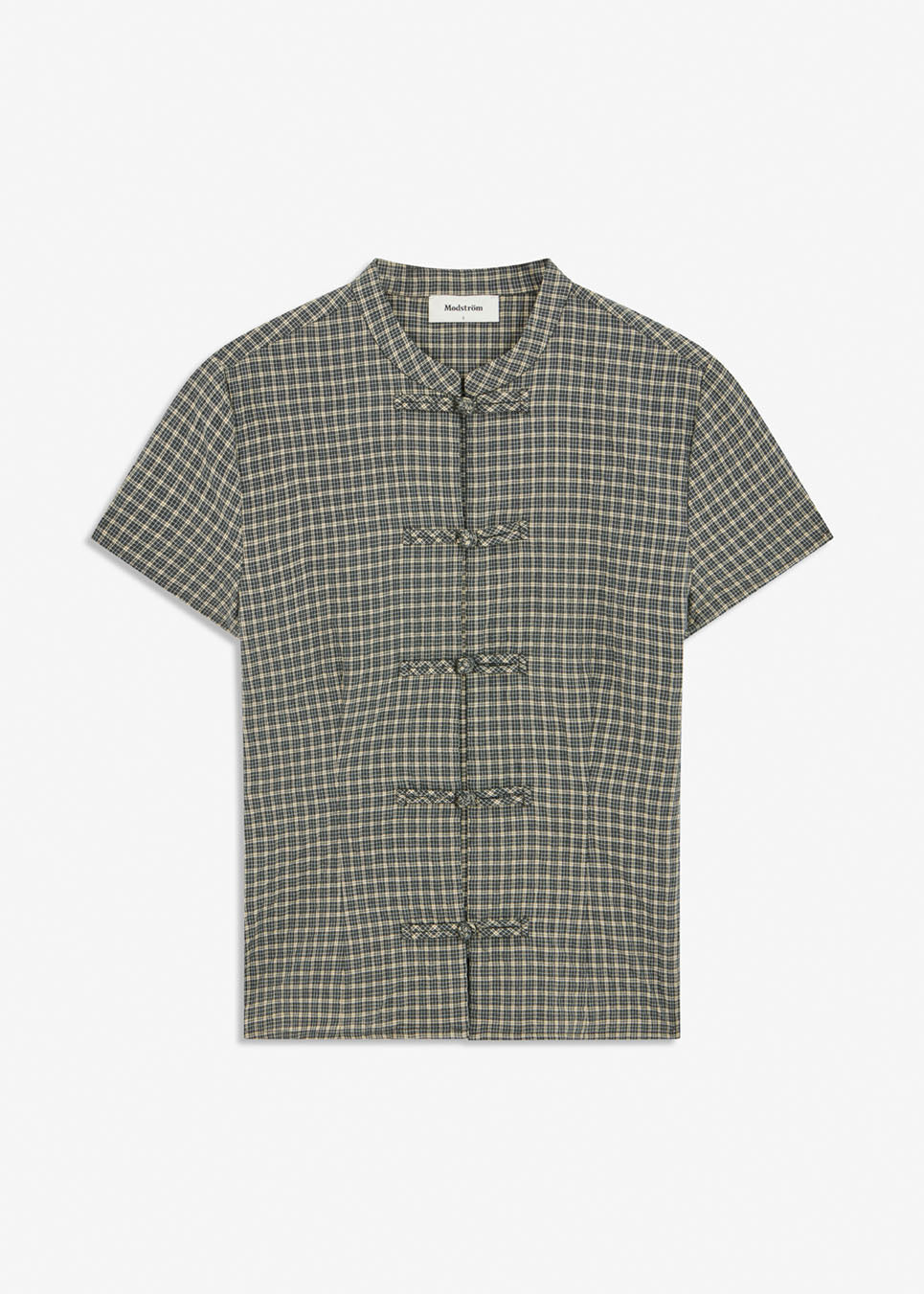 TikkaMD Top is a short-sleeved top with a relaxed fit and classic checked pattern. The design features a round neckline and decorative button fastenings at the front. Style it with jeans or matching Tikkamd Skirt.&nbsp;
