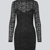 Fitted black lace dress in a see-through lace material. TildeMD dress has long sleeves, a high neck and lining.