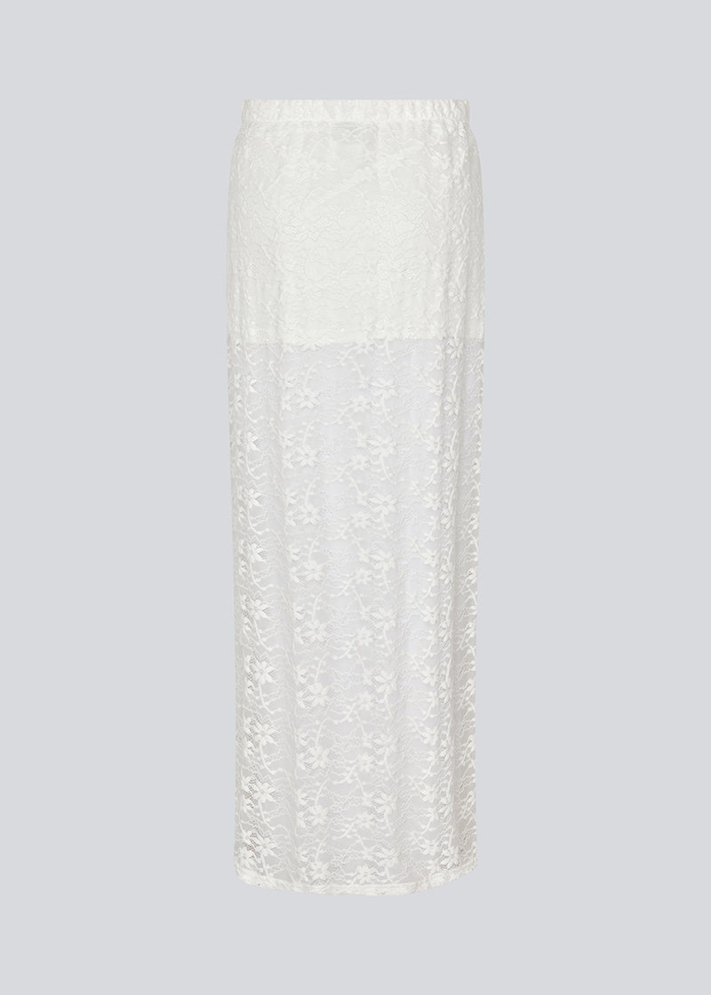 Maxi skirt in a white see-through lace material. TildeMD skirt has a lining and an elastic waistband.