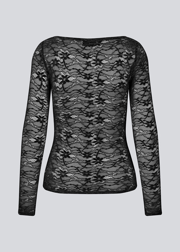 Fitted black top in a see-through lace material. TildeMD top has long sleeves and a wider neckline.