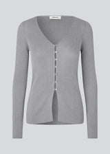 Fine knit cardigan with a v-neck. TomMD cardigan has long sleeves and a button closure in front. 