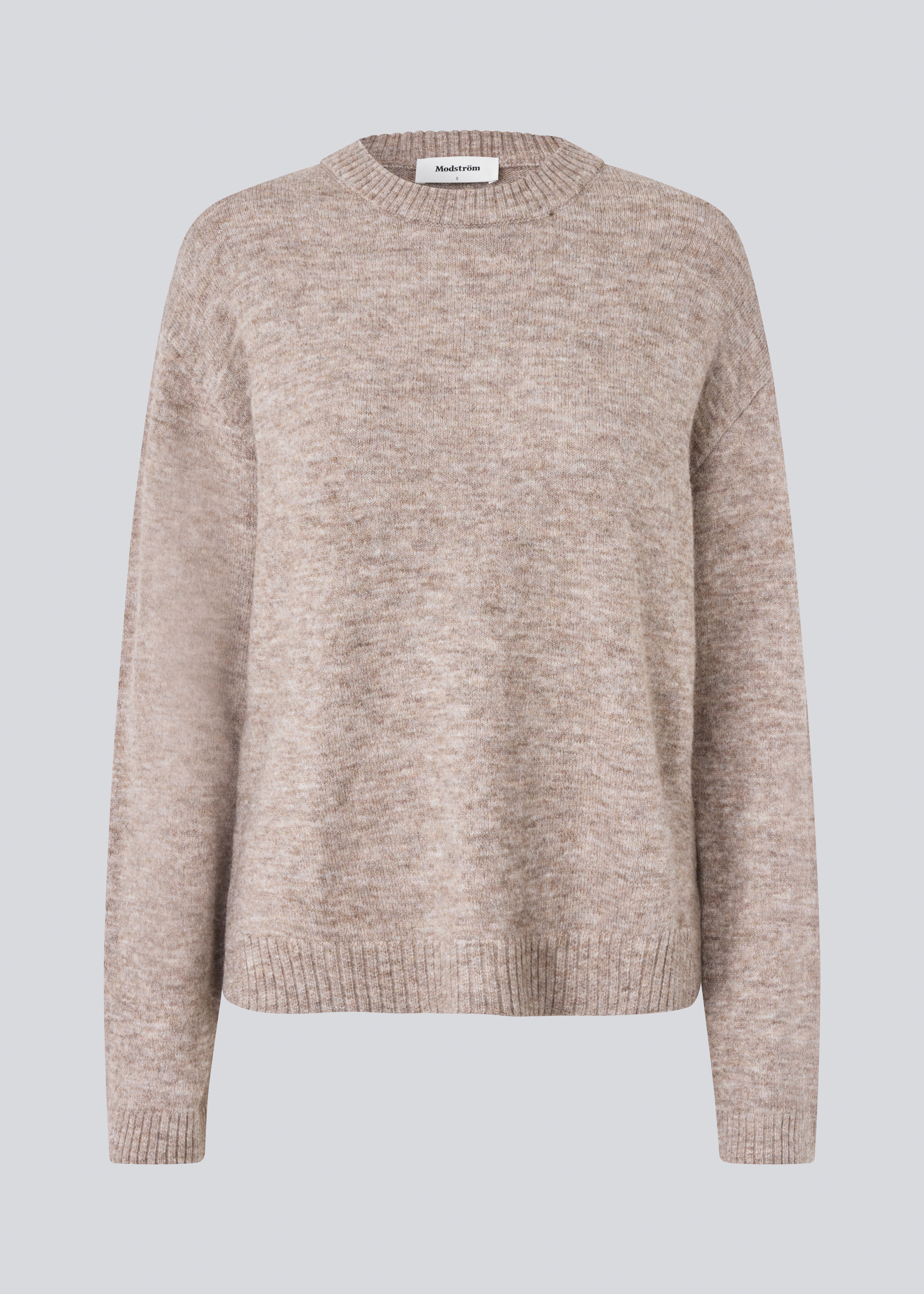 Loose knit in beige melange in plain jersey knit. TreeMD o-neck has a round neckline and long loose sleeves.
