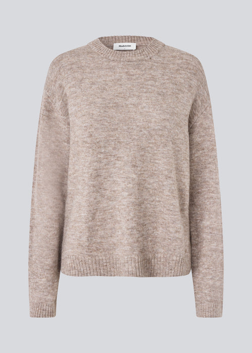 Loose knit in beige melange in plain jersey knit. TreeMD o-neck has a round neckline and long loose sleeves.
