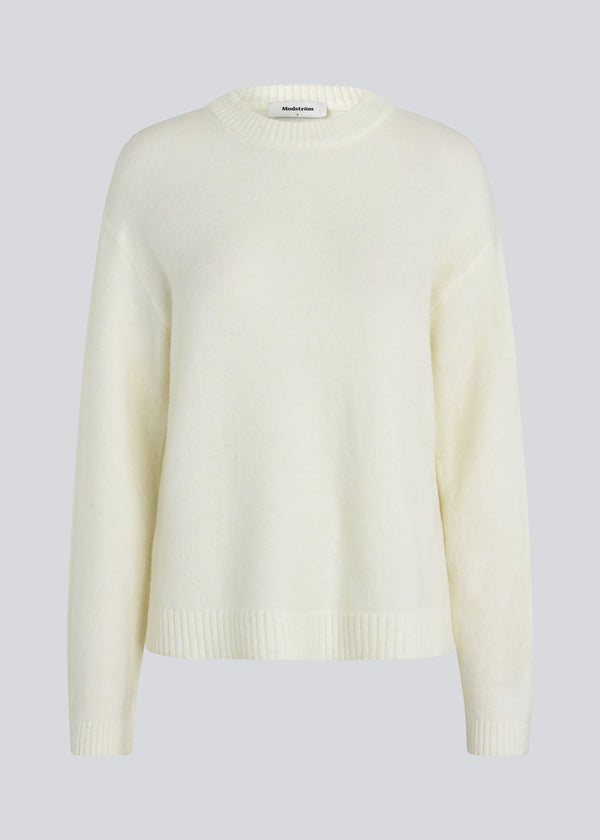 Loose off white knit in plain jersey knit. TreeMD o-neck has a round neckline and long loose sleeves.
