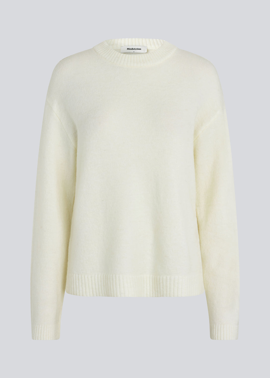 Loose off white knit in plain jersey knit. TreeMD o-neck has a round neckline and long loose sleeves.
