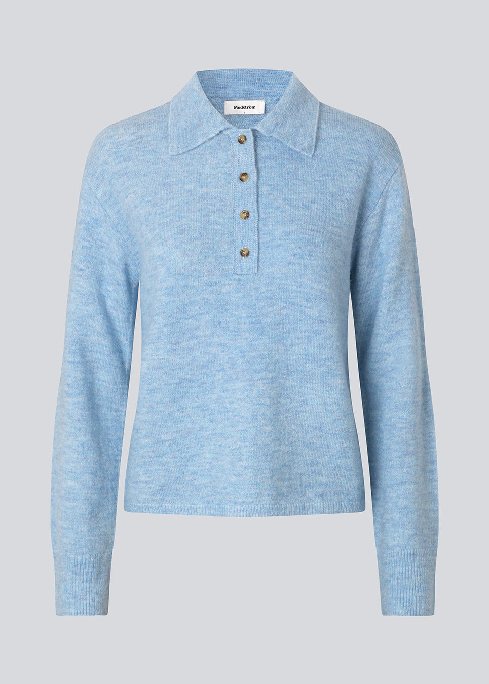 Knitted polo in blue with long sleeves. Treemd polo has a placket closure and 4 buttons. The model is 175 cm and wears a size S/36.