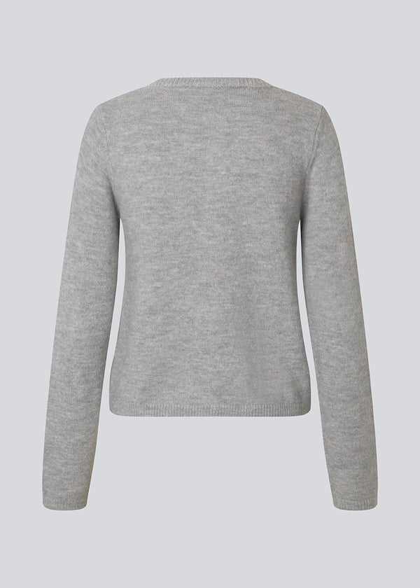 Light grey fitted cardigan in soft knit. The TreeMD cardigan features a round neckline and delicate buttons in a matching color, highlighting its simple and feminine expression.