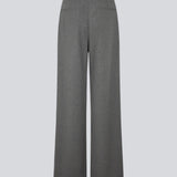 Grey suit pants with pleats and wide legs. Tuesdaymd pants have a medium-highwaist, zipper, side pockets and paspoil pockets in the back. The model is 175 cm and wears a size s/36.
