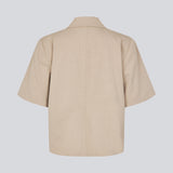 Short-sleeved blazer with a single-button closure. The TuesdayMD SS Blazer features a crossover button closure, collar, side pockets, and a faux chest pocket – a modern twist on a timeless classic. Can be worn closed as an elegant top or open over a light blouse for a more relaxed look.