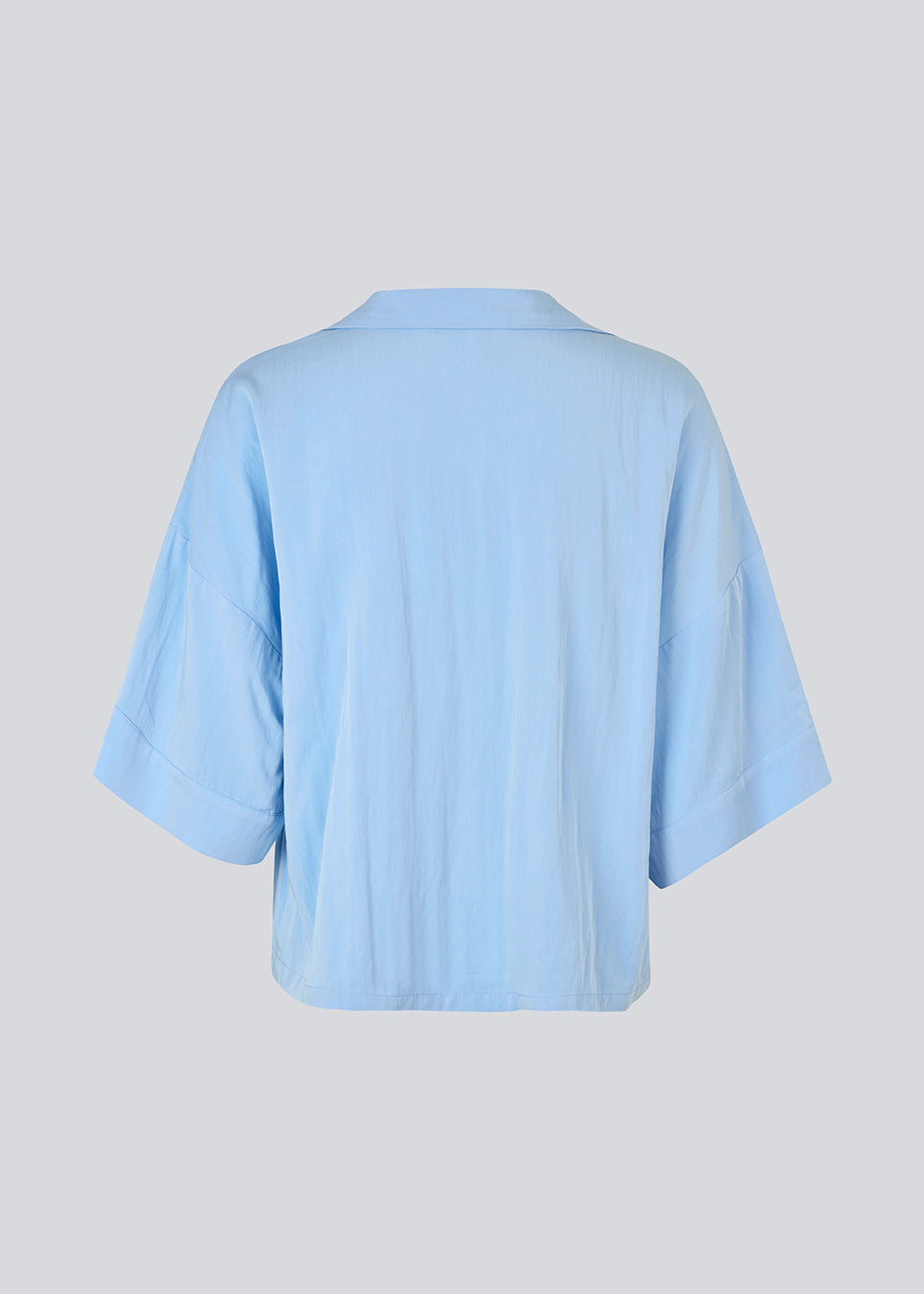 Minimalist shirt in light blue with wide 3/4 sleeves. The UddinMD Shirt features a loose and comfortable fit, a classic shirt collar, a feminine V-neckline, and button closure. Modellen er 175 cm og har en str. S/36 på.

Material:
27% Polyamide
73% Viscose