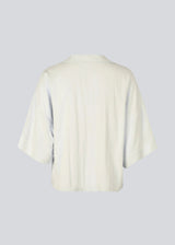 Minimalist shirt in beige with wide 3/4 sleeves. The UddinMD Shirt features a loose and comfortable fit, a classic shirt collar, a feminine V-neckline, and button closure.

Material:
27% Polyamide
73% Viscose