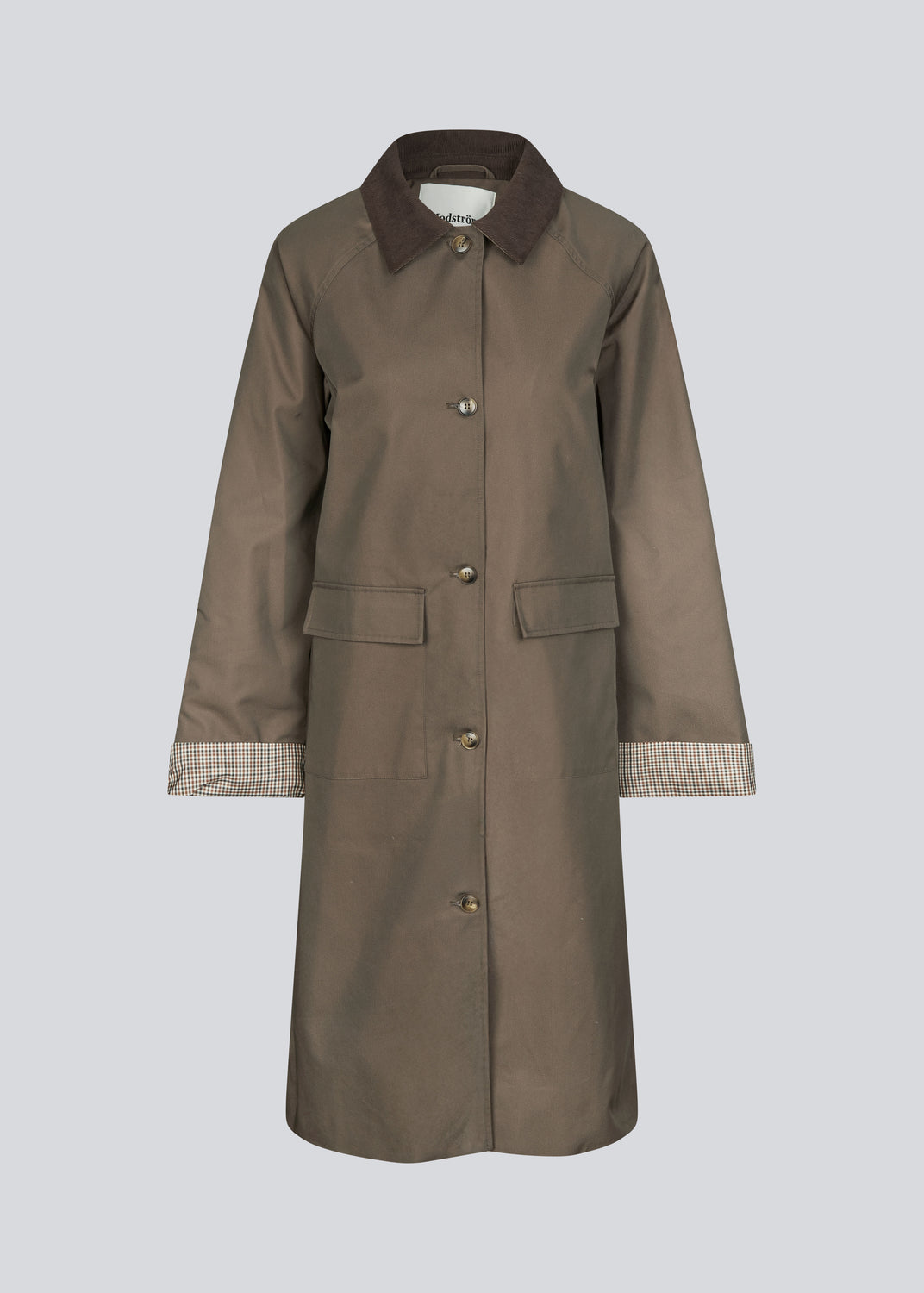 Modern coat with a shirt collar in corduroy and checked sleeve turn-ups. The Ullamd coat is long with wide sleeves, button closure, and spacious pockets.